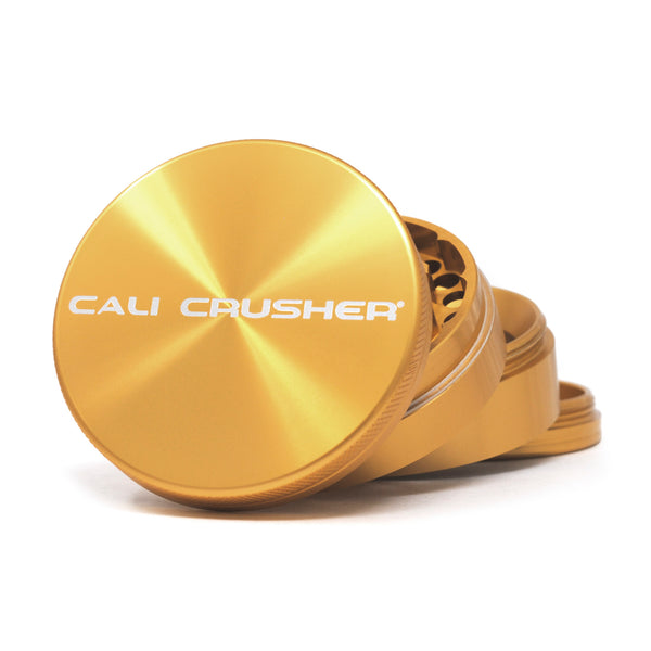 Gold Cali Crusher O.G. Hard Top 2.5 inch 4-piece herb grinder, closed top lid with white brand logo