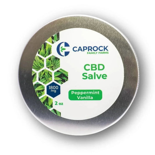 Top of a 2 oz metal tin of Caprock Family Farms 1800mg CBD Salve in Peppermint Vanilla, green leaf hexagon label