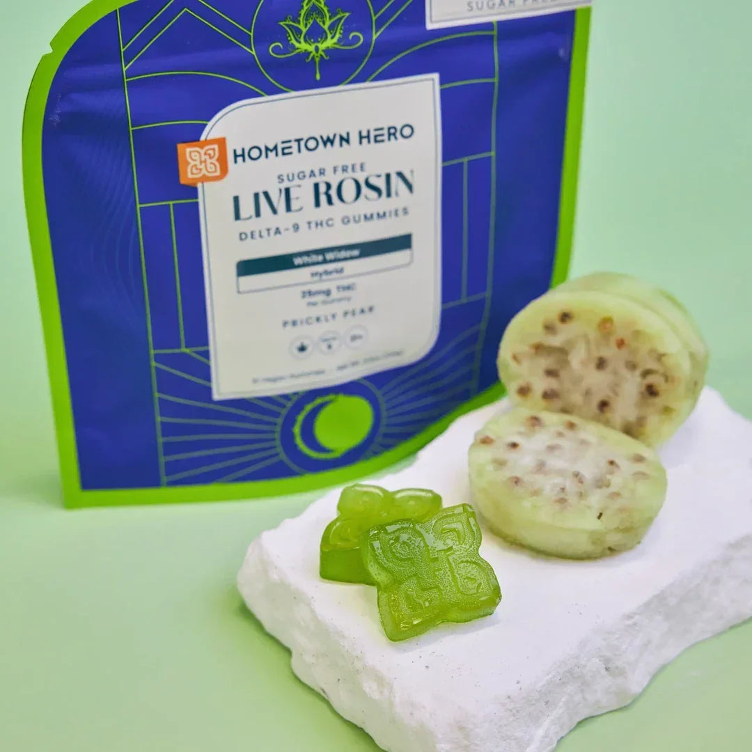 Hometown Hero Prickly Pear White Widow Live Rosin gummies with green gummies and sliced prickly pear fruit